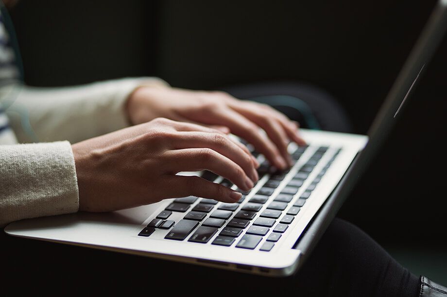 Hands on the keyboard of a laptop