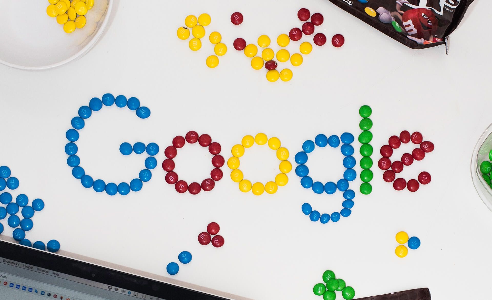 The word Google laid out in coloured chocolate buttons