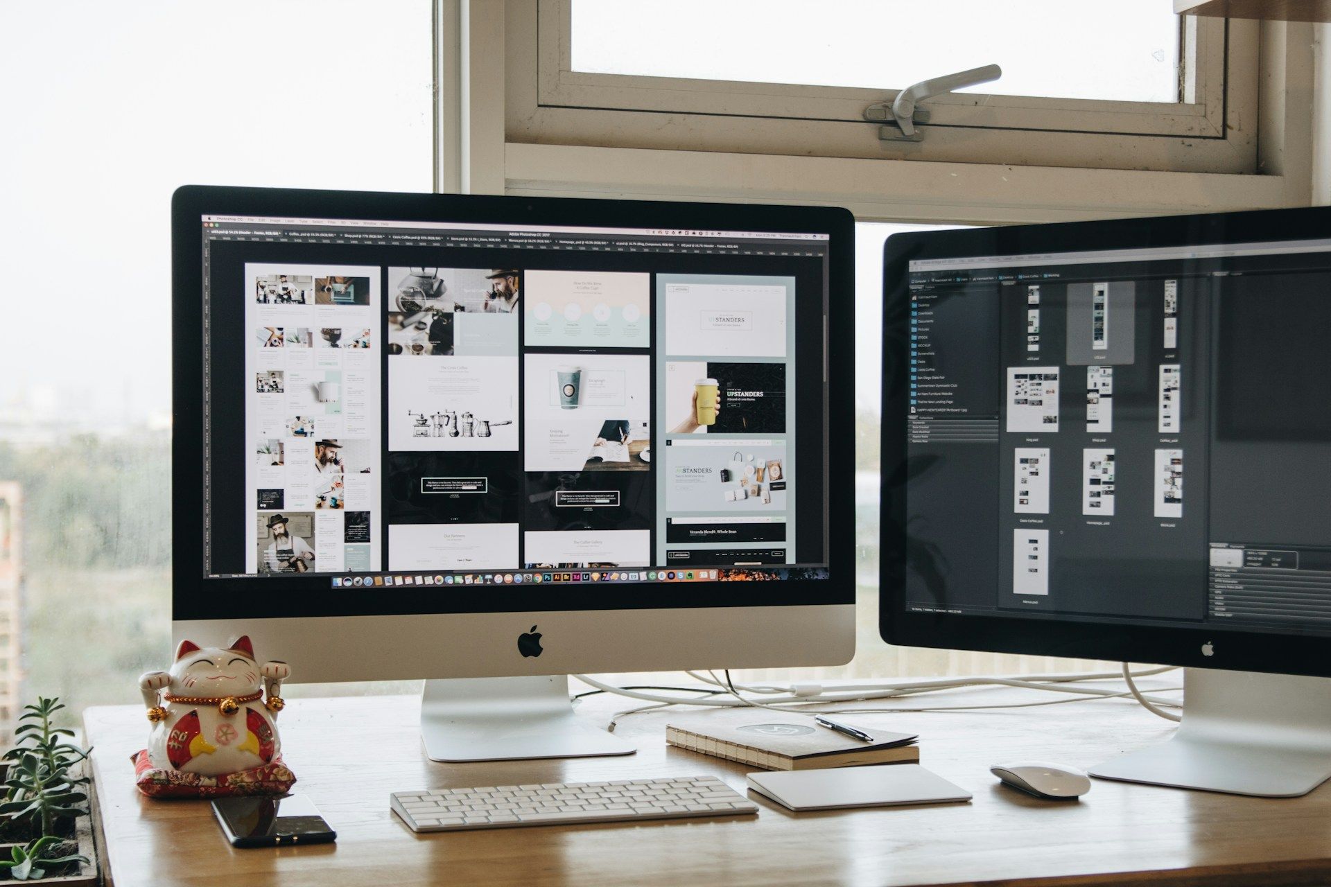 Workplace with 2 screens showing website designs