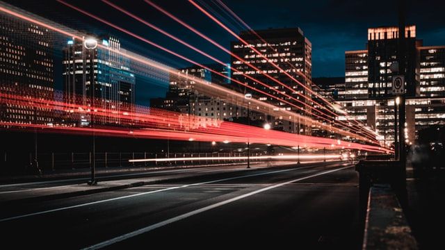 City at night with red light trails from cars
